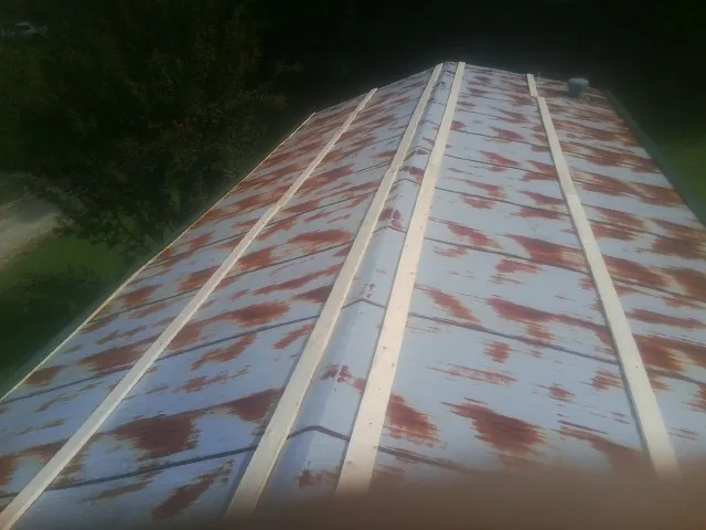 Rusted metal roof panels with new wood purlins before replacement — Storm Damage Roof Repair in Danville by Roofing Brothers